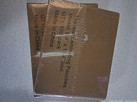 Two sealed packs of thermal laminating pouches