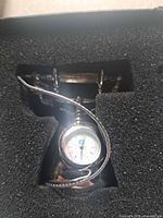 Clock seated in foam insert inside the original box