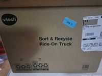 Sealed outer carton with VTech Sort & Recycle Ride-On Truck branding