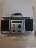 Front view showing speakers, controls, and analog dial
