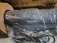 Laminator unit in protective plastic showing Scotch branding and power cord