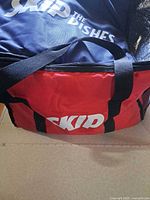 Red SkipTheDishes insulated delivery bag with black handles