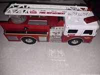 Side view showing Tonka fire truck, ladder, decals, wear