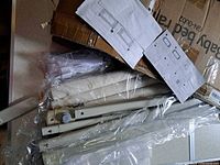 Disassembled bed rail components, hardware, instructions and box