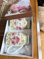 Two floral porcelain mugs seated in gift box