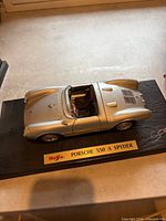 Top view of silver Porsche 550 A Spyder model on display base