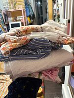 Stack of assorted linens showing colors and patterns