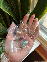 Five pairs stone chip earrings in individual plastic bags on hand