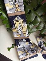 Full view of necktie showing dog illustrations and colour scheme