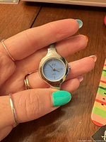 Front view showing light blue QS dial and case
