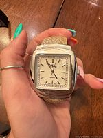 Front view of Mira square stainless steel wristwatch on hand
