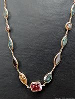 Full view of gold necklace with multicolour diamond stations