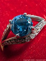 Top view of ring showing blue diamond and accent stones
