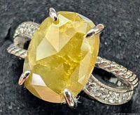 Top view of ring showing oval yellow diamond and accent diamonds