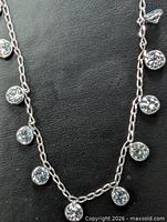 Full view of the necklace showing chain and bezel-set moissanite stones