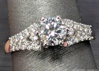 Ring front view showing center diamond and pavé shoulders