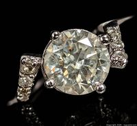 Close-up of round brilliant center diamond and accent diamonds