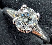 Top view showing round center diamond in prong setting