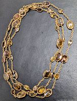 Full view of necklace laid flat showing gold chain and bezel-set diamonds