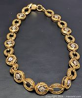 Full view of two-tone gold bracelet showing link pattern and clasp