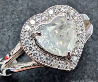 Top view showing heart-cut center diamond and halo of accent diamonds