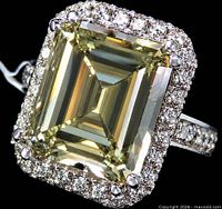 Front view showing rectangular centre diamond, halo, and diamond shoulders