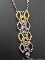 Front view of two-tone gold pendant showing marquise links and diamonds