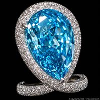 Front view of pear-cut vivid blue diamond ring with pavé halo and crossover shank