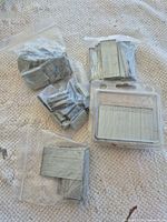 All bags and clamshell of brad nails and staples on surface