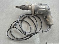 Full view of Black & Decker Professional corded drywall drill with coiled power cord