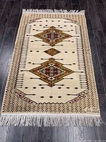 Full view of rug showing overall pattern, colour and fringe
