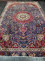 Full view of Persian Tabriz rug showing entire design and fringe