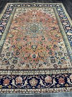 Full view of entire Mashhad rug showing field, borders, fringe