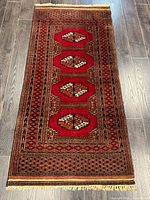 Full view of Turkman runner rug showing complete design and fringe