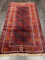 Full view of Baluchi rug showing overall pattern and fringe