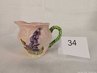 Left side profile of creamer showing foxglove design and lot tag