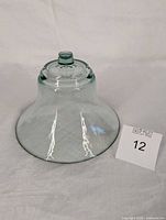 Side view of glass cheese cloche showing overall shape and knob
