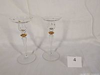 Front view of both clear glass candlestick holders