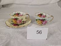 Front view of yellow teacup with saucer and blue teacup