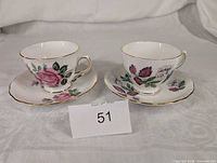 Front view of both teacup and saucer sets displaying floral patterns