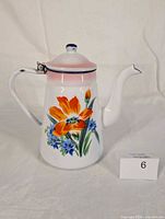 Front view of enamel pot showing main floral design and overall condition