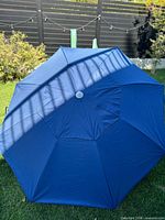 Full view of open blue beach umbrella