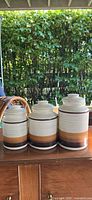 Front view of all three ceramic canisters with lids