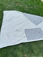 Duvet cover laid out showing striped side and solid grey reverse plus shams