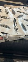 close view of feather print cover showing zipper