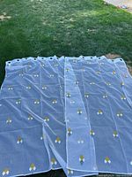 Two sheer white Simons Maison panels laid out showing full size and pattern