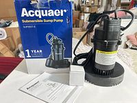 Pump, box, manual and accessory on table