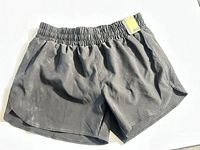 Front view of black athletic shorts with tag
