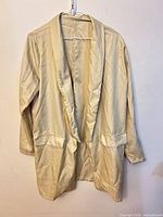 Front view of cream blazer on hanger