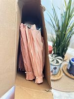 Folded peach crepe paper inside box
